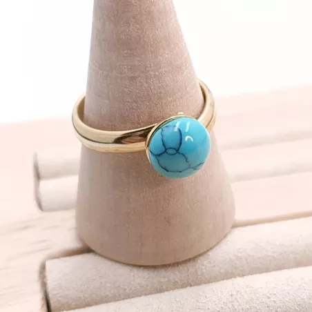 la bague gentiane, ajustable et ornée d'une pierre naturelle turquoise, est en acier inoxydable doré.